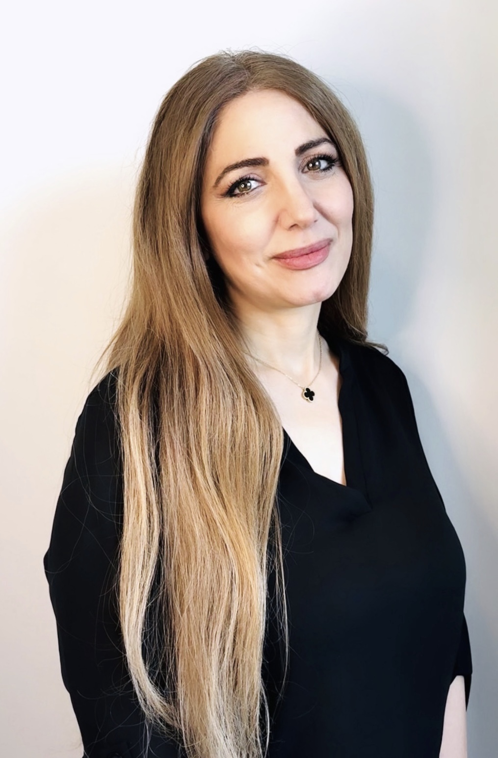 Dr. Kady, smiling human development specialist, founder of bloombyme, promoting mental health awareness and social emotional wellness